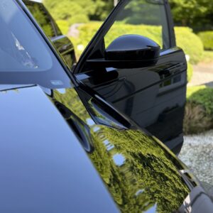Luxury car paint protected with ceramic coating showing deep gloss and mirror reflection by ATO GROUP